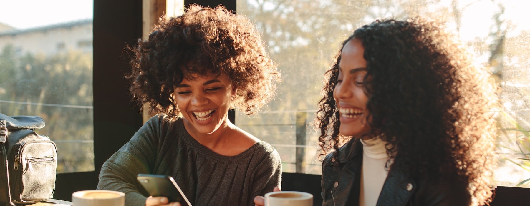 friends having coffee together and laughing